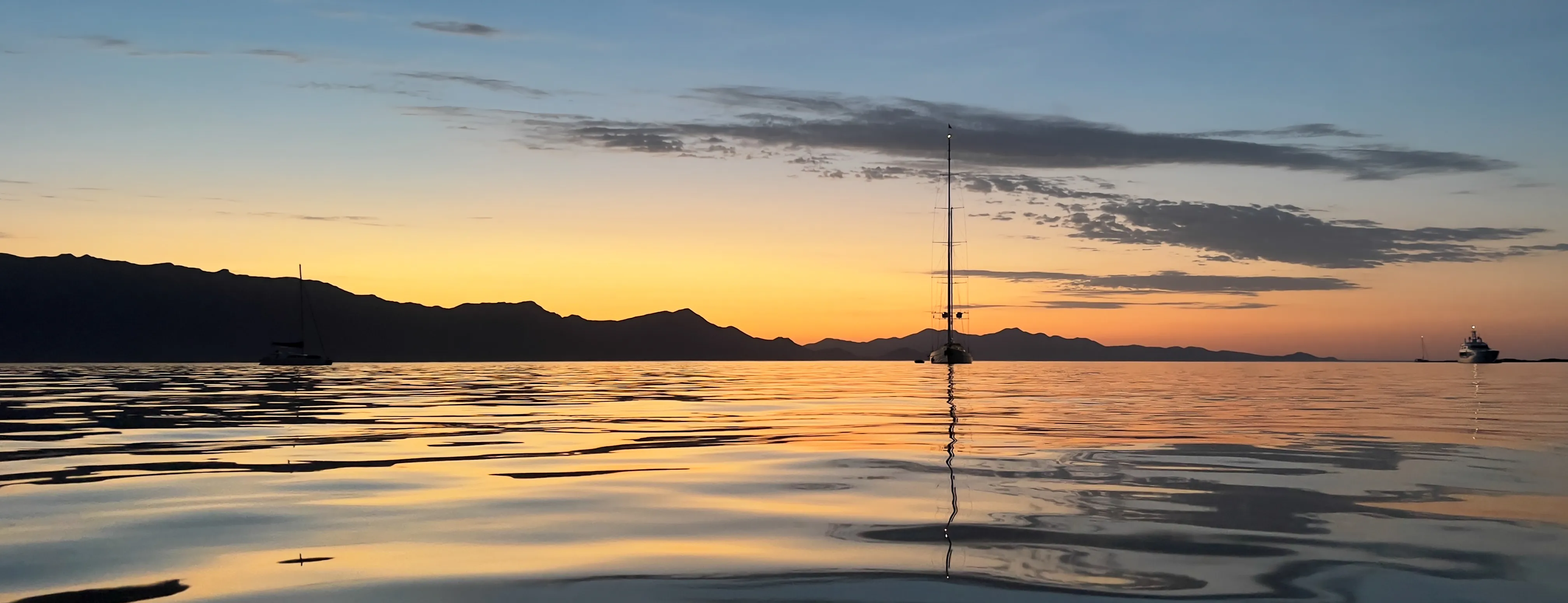 Sunset over the sea with a sailboat